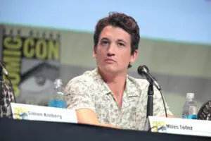 Miles Teller sitting