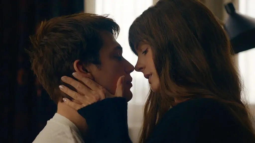 The Idea of You - Nicholas Galitzine and Anne Hathaway about to share a kiss