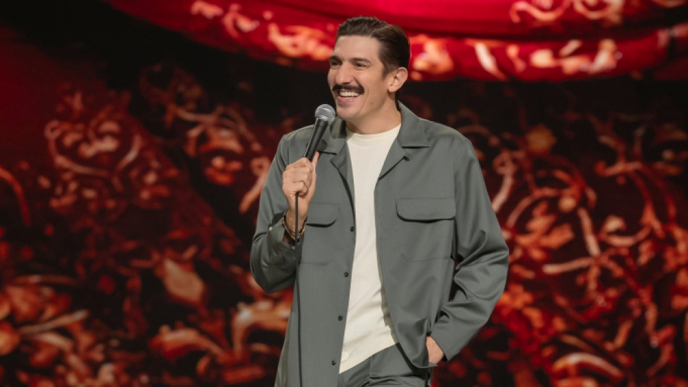 Andrew Schulz performing at NYC's Beacon Theatre in his Netflix special, Life