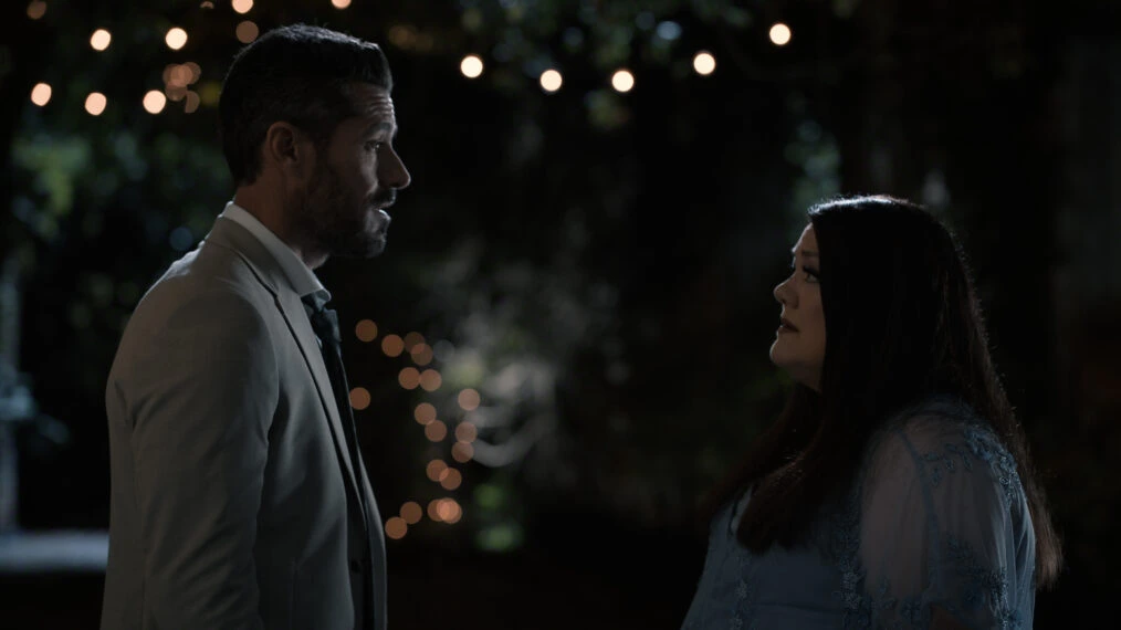 Ronnie and Dana Sue looking at each other with tense expressions during a night scene in Netflix's Sweet Magnolias Season 5