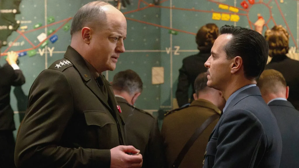 Brendan Fraser as General Dwight D. Eisenhower and Andrew Scott as James Stagg speaking face-to-face in front of a war map in Pressure
